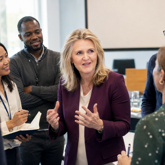 Kate Cook discussing employee wellbeing initiatives with employees